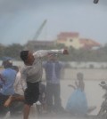 A protester supporting the opposition Cambodia National Rescue Party (CNRP) throws a stone during clashes with police near the Royal Palace in central Phnom Penh