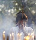 A woman prays during the annual Meak Bochea ceremony at the Oudong mountain in Kandal province