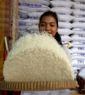 A woman cleans rice for sale in Phnom Penh