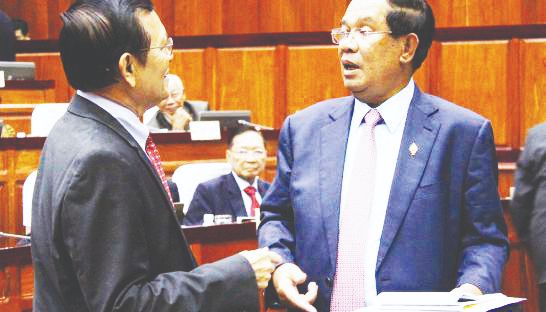 1_prime_minister_hun_sen_right_and_deputy_opposition_leader_kem_sokha_meet_at_the_national_assembly_yesterday_in_their_first_encounter_since_sokha_was_pardoned_for_alleged_prostitution_07_12_2016_afp