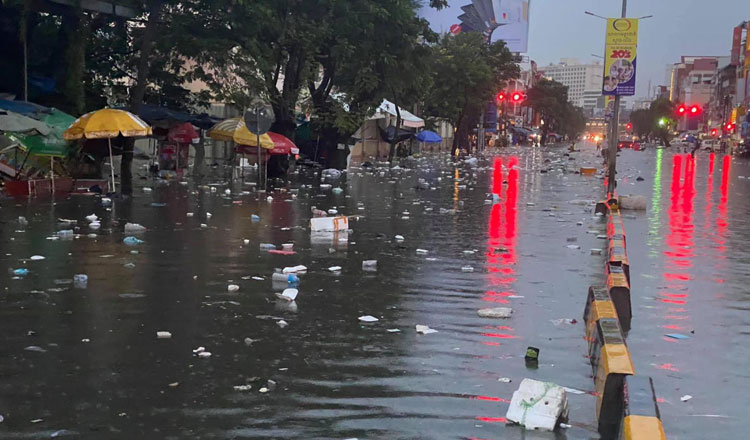 Garbage flows down Mao Tse Toung Boulevard in the capital yesterday. Facebook